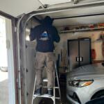 Rainbow Garage Door Service Tech repairing a broken spring