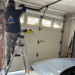 Rainbow Garage Door Service Tech repairing a broken garage door spring