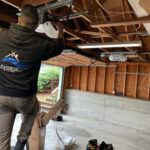 Rainbow Garage Door Service Tech repairing a garage door opener