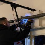 Rainbow Garage Door Service Tech repairing a garage door